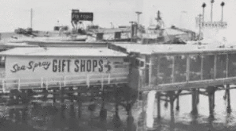 Historic pier with a gift shop sign at Hawthorne's waterfront.