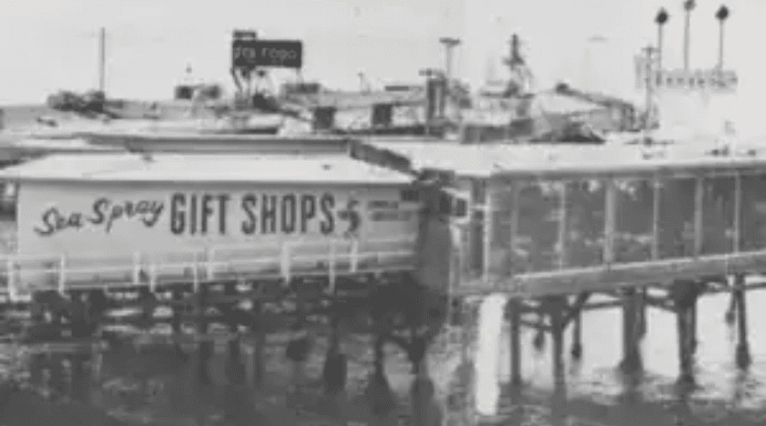 Historic pier with a gift shop sign at Hawthorne's waterfront.
