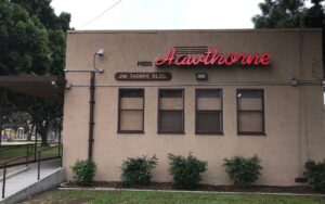 Exterior view of the Hawthorne Historical Society building with signage and surrounding greenery, highlighting the community's historical preservation efforts.