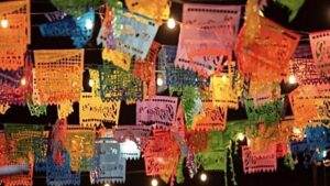 An image showcasing colorful papel picado banners hanging at a Hawthorne Historical Society event, celebrating local culture and community heritage.