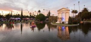 Scenic view of Hawthorne Memorial Park with the monument, pond, and palm trees during sunset, featured in the October 2023 newsletter.