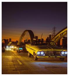 Vintage cars parked along Hawthorne street at dusk during the October 2023 newsletter event.