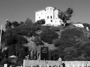 Historic Getty Villa atop a hillside, showcasing classical architecture surrounded by lush greenery, representing Hawthorne Historical Society's focus on local history.
