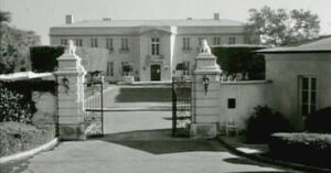 Historic Hawthorne Society mansion with grand entrance gate.