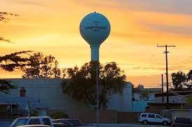Iconic Hawthorne Water Tower against a sunset sky, representing local history and community pride. Perfect for the Hawthorne Historical Society's September Newsletter 2023.