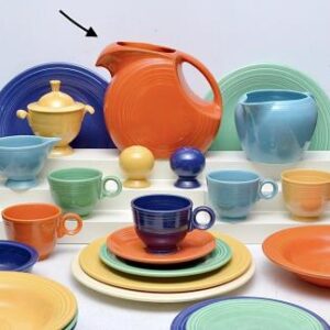 Vibrant ceramic dishware collection featuring plates, bowls, cups, and a teapot in various bright colors.
