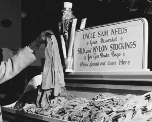 Uncle Sam needs your discarded silk and nylon stockings for gun powder bags, as shown in a historical black-and-white photo.