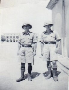 Two women in vintage military uniforms standing outdoors, historical photo from Hawthorne Historical Society.