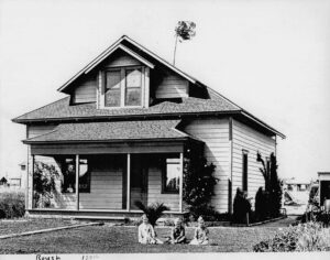 Historic Hawthorne house with children playing outside.