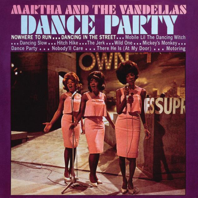 Vintage Motown girl group performing on stage at a dance event, capturing the lively spirit of the 1960s dance parties.