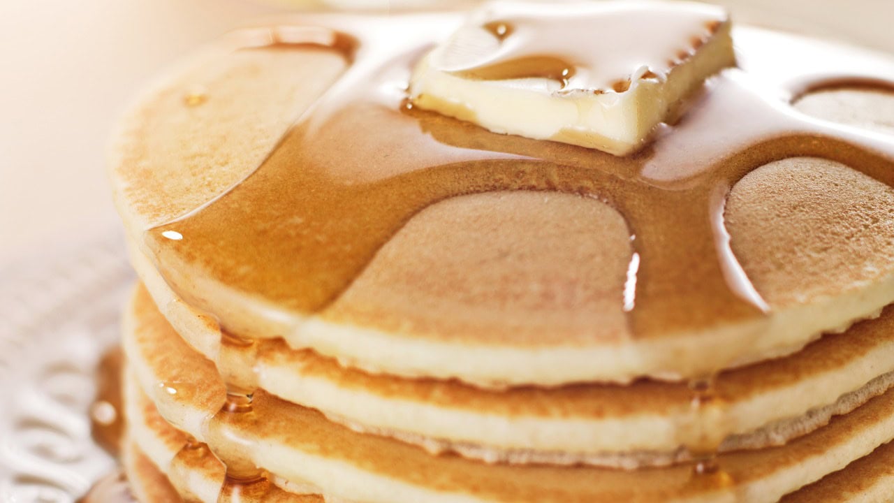 Close-up of a stack of fluffy pancakes topped with butter and syrup, served at the 2025 Hometown Pancake Breakfast event hosted by Hawthorne Historical Society.