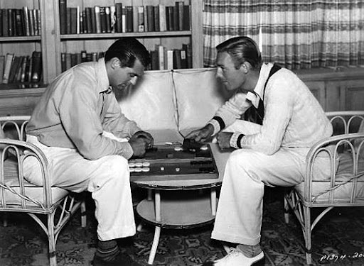 Two men playing a board game during a museum event, showcasing community engagement at Hawthorne Historical Society.