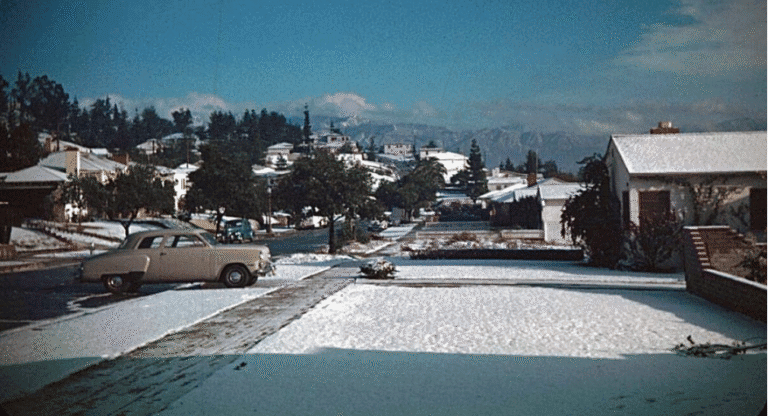 Snow-covered street scene in Hawthorne with historic buildings and parked cars, showcasing the town's winter charm and historical architecture.