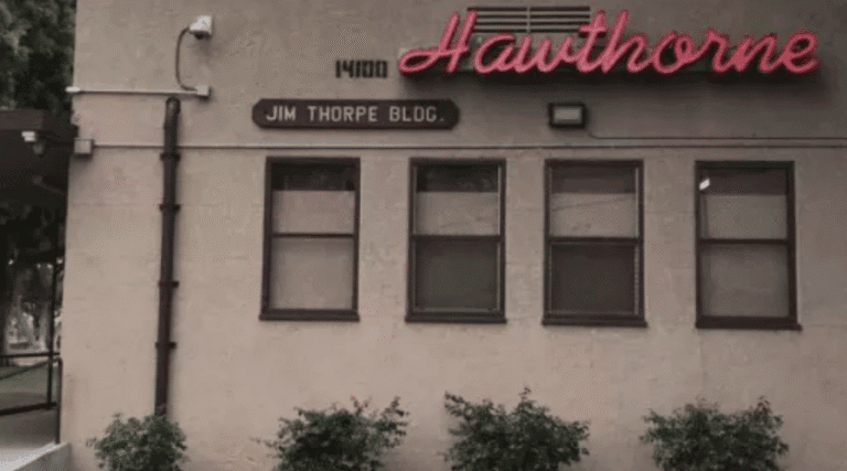 Historic Hawthorne building with Jim Thorpe Blvd sign, showcasing vintage architecture and local history.