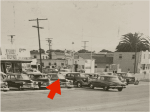 Vintage cars parked along Hawthorne street in a historic downtown scene.