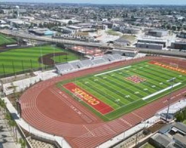 Aerial view of Hawthorne High School's new athletics complex featuring a football field and running track, highlighted during the ribbon-cutting ceremony.
