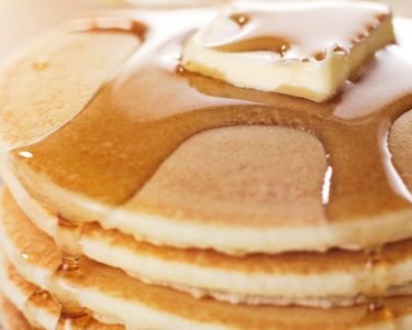 Close-up of a stack of fluffy pancakes topped with butter and syrup, served at the 2025 Hometown Pancake Breakfast event hosted by Hawthorne Historical Society.