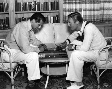 Two men playing a board game during a museum event, showcasing community engagement at Hawthorne Historical Society.