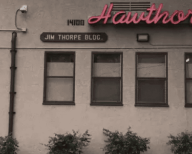 Historic Hawthorne building with Jim Thorpe Blvd sign, showcasing vintage architecture and local history.